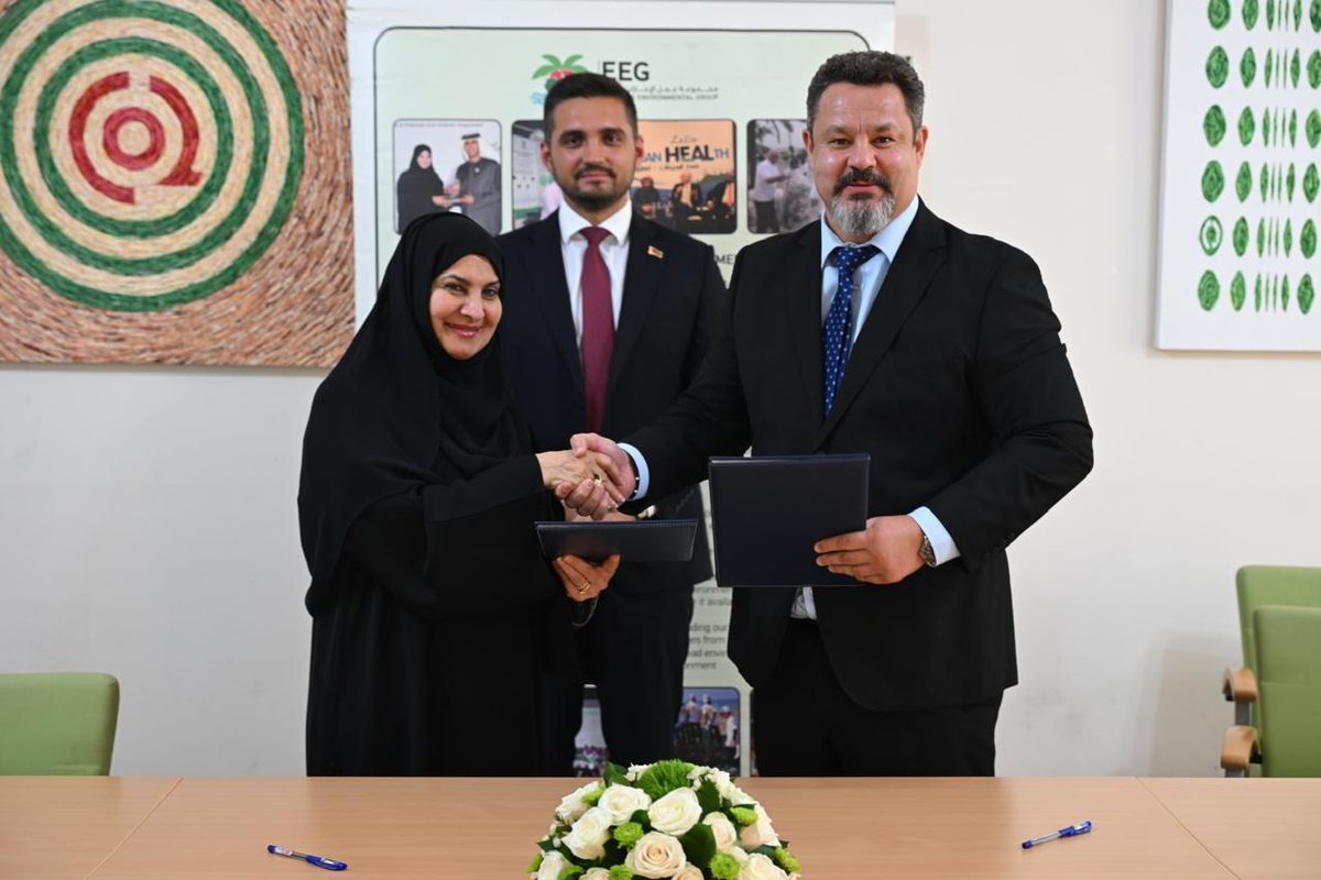 Dr. Habiba Al Mar'ashi and Maksim Barziankou shake hands after signing the MoU